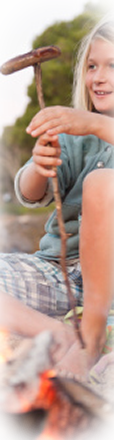 boy holding sausage on stick